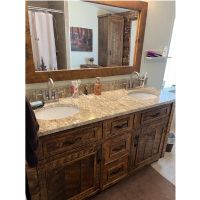 Customer photo of a double sink vanity with a custom granite top, shown in Antique Barnwood finish.